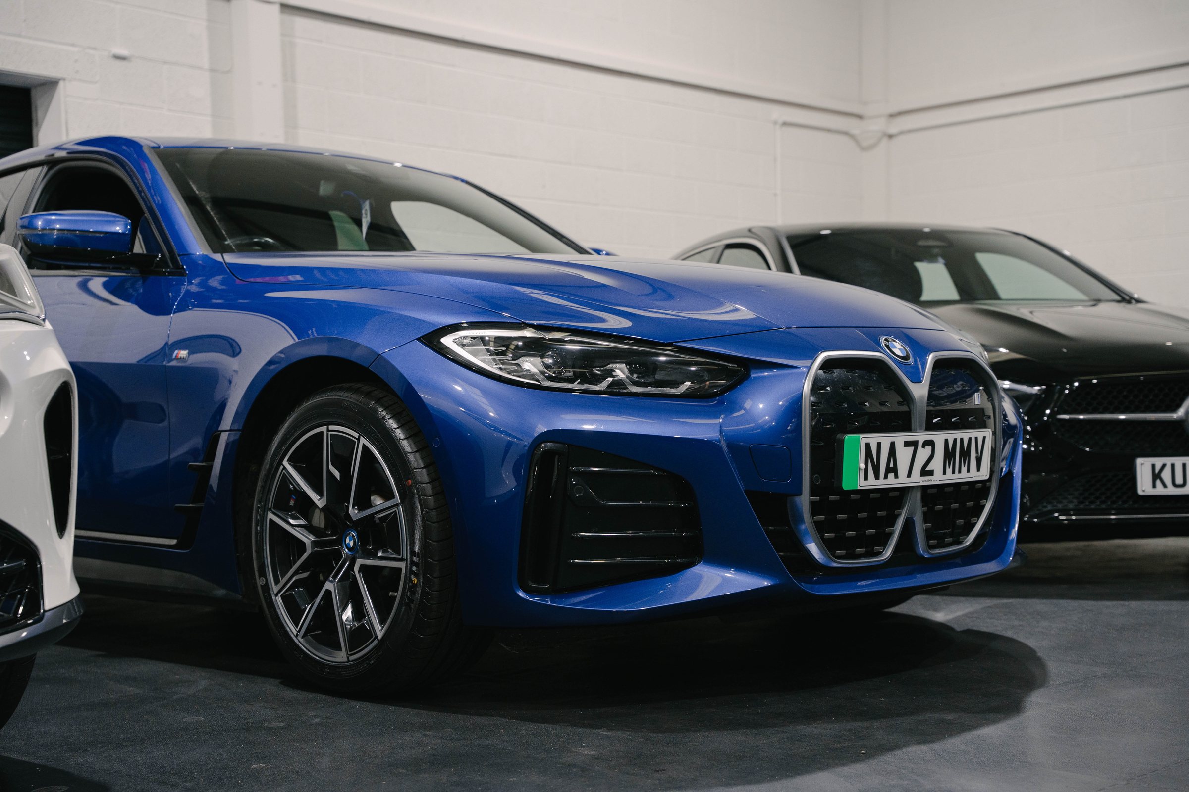 Blue BMW i4 in the RW Cars showroom