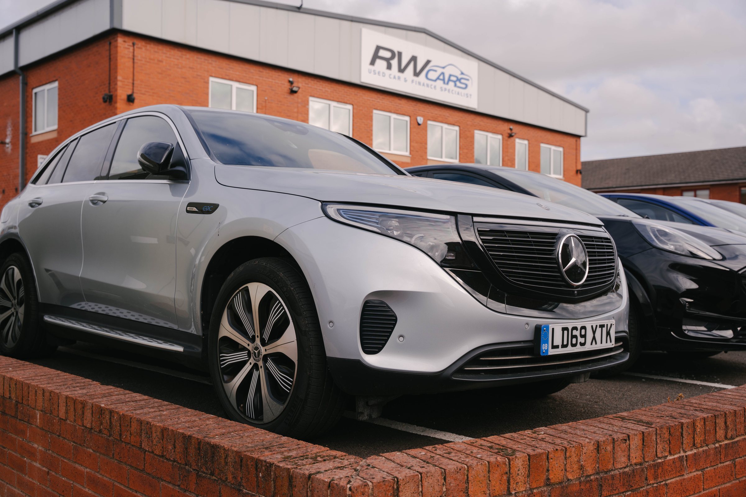 Silver Mercedes EQC parked outside the RW Cars building in Derby