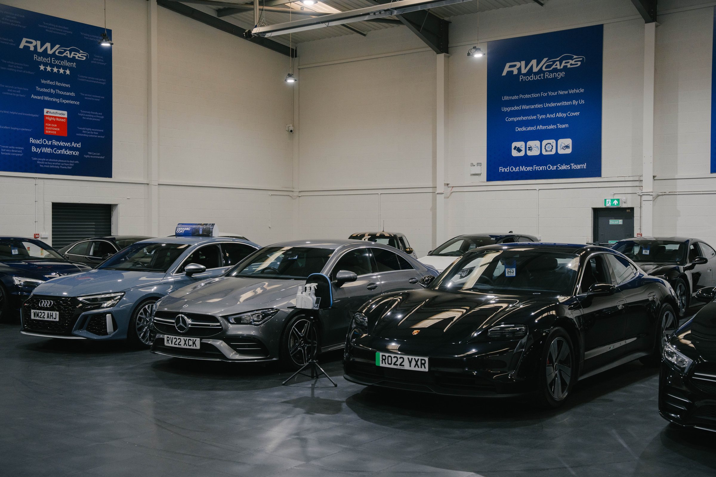 Inside the RW Cars showroom in Derby, cars lined up under the RW Cars banners